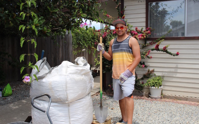 Young man with a shovel.